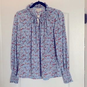 Flowery soft blue blouse for work or leisure.